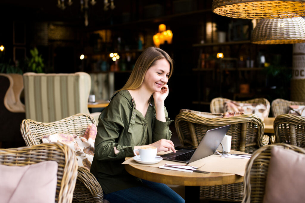 Dark Academia Outfit Post Image - someone sitting in a cafe writing in a notebook